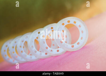 Adhesive tape for dispenser on a gold and pink background. Items for office work. Horizontal image Stock Photo