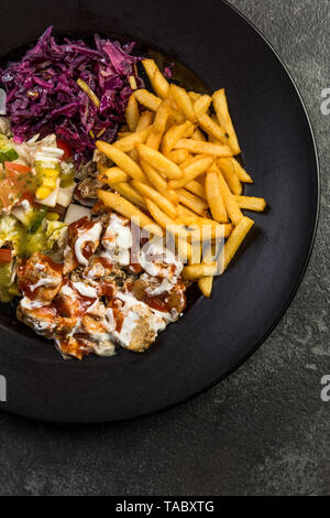 Turkish donner kebab with fries and salad on plate. Stock Photo