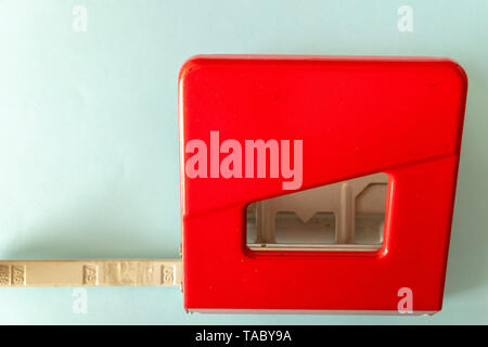 red hole punch on blue background in the office Stock Photo