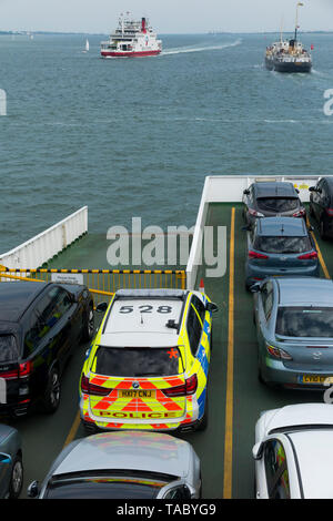 Open car deck of a Red Funnel ferry sailing between UK mainland Southampton and Cowes on the Isle of Wight. Passenger vehicles making the crossing include a police car. (99) Stock Photo