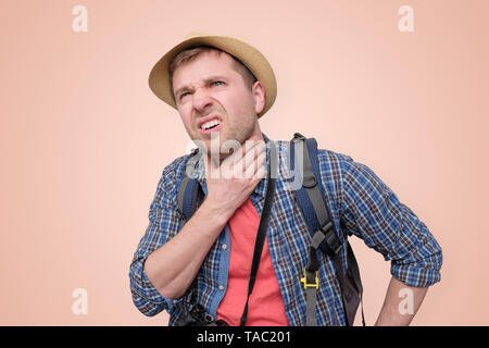 man in summer hat suffering from the pain in his throat Stock Photo