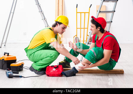 Injured worker and his workmate Stock Photo