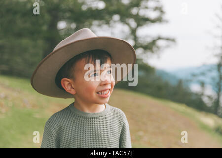 Portrait of a little boy, wearing his mother's hat Stock Photo