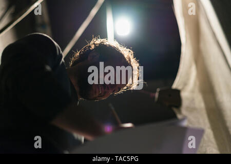 Portrait of happy man in theatre working on script Stock Photo