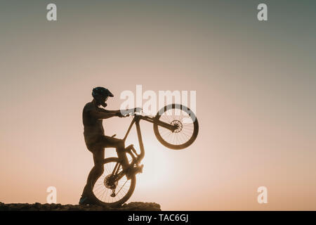 Spain, Lanzarote, mountainbiker on a trip at sunset Stock Photo