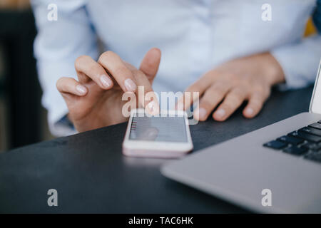 Hand of businesswoman, using smartphone Stock Photo