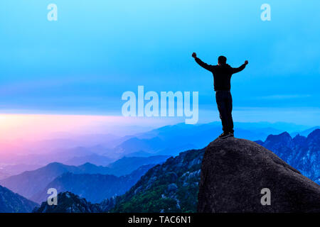 Happy man gesture of triumph with hands in the air,conceptual scene Stock Photo