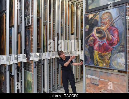 20 May 2019, Brandenburg, Beeskow: Florentine Nadolny, director of the art archive, stands in the 'heart' of the new depot with innumerable pulling grids to which pictures from GDR times are attached. 30 years after the fall of communism, GDR art is finding interest again, especially among those who did not experience this state for themselves. The Beeskow Art Archive wants to make a contribution to this with its new open depot. It has around 23,000 GDR commissioned works of art in its inventory, which are now more easily accessible. The art archive is scheduled to open on 29.05.2019. Photo: P Stock Photo