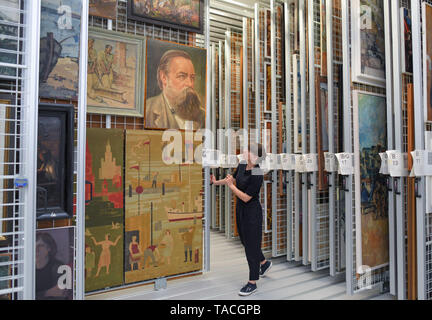 20 May 2019, Brandenburg, Beeskow: Florentine Nadolny, director of the art archive, stands at the heart of the new depot with countless pulling grids to which pictures from GDR times are attached. 30 years after the fall of communism, GDR art is finding interest again, especially among those who did not experience this state for themselves. The Beeskow Art Archive wants to make a contribution to this with its new open depot. It has around 23,000 GDR commissioned works of art in its inventory, which are now more easily accessible. The art archive is scheduled to open on 29.05.2019. Photo: Patri Stock Photo