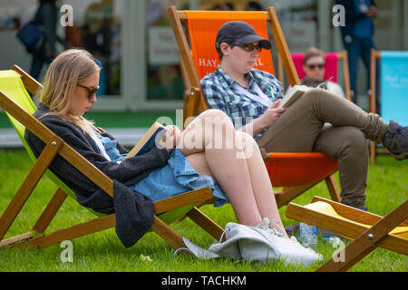 The Hay Literature Festival, Hay on Wye, Wales UK Friday 24 May 2019.   Relaxing  with a good book  on lawn on  the 2nd day of the 32nd annual Hay Festival of Literature and the Arts.  The festival attracts the finest writers and thinkers from  across the globe for 10 days of celebration of the best of the written word and critical debate  Photo © Keith Morris / Alamy Live News Stock Photo