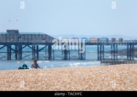 Hastings, East Sussex, UK. 24 May, 2019. UK Weather: Hot and sunny day in the seaside town of Hastings on the South East coast. The shimmering heat from the beach is noticeable as a few people lie and sunbath in the glorious sunshine. Photo Credit: Paul Lawrenson/Alamy Live News Stock Photo