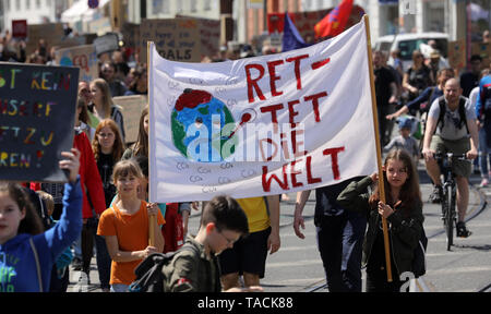 Rostock, Germany. 24th May, 2019. Pupils demonstrate with protest posters with the inscription 'Save the World' during the Fridays for Future - climate strikes for the implementation of the Paris Climate Agreement. The call for demonstrations was also made against the background of the current European elections. Credit: Bernd Wüstneck/dpa/Alamy Live News Stock Photo