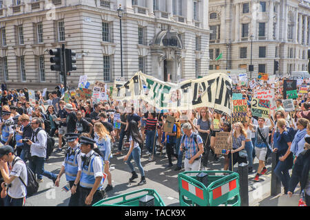 London, UK. 24th May, 2019. Hundreds of young school students march with placards through Whitehall to demand climate justice to demand on the government to take urgent action over the climate crisis Credit: amer ghazzal/Alamy Live News Stock Photo