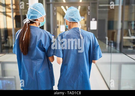 Two doctors or nurses in blue surgical clothes are on standby Stock Photo