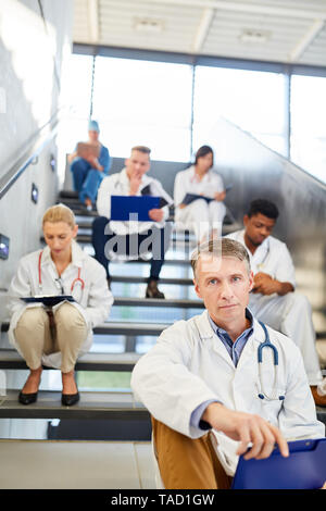 Senior physician and medical team with nurses and nurses in the stairwell of the clinic Stock Photo