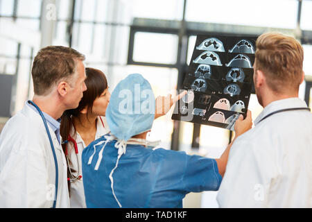 Medical team evaluating and discussing MRI section image in radiology Stock Photo