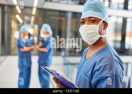 African doctor as an emergency medic with clipboard in front of the emergency department of the clinic Stock Photo