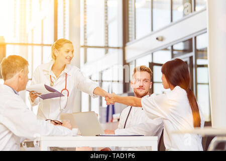 Doctors give handshake to greeting at meeting in a hospital Stock Photo