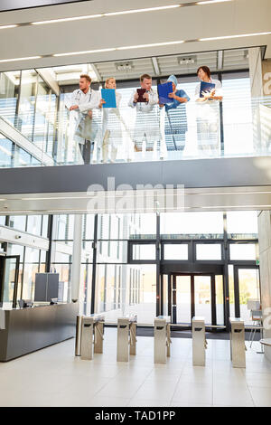 Medical team at a team meeting on the gallery of the entrance hall of the clinic Stock Photo