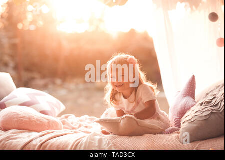 Happy child girl 1-2 year old wake up in bed. Good morning. Stock Photo