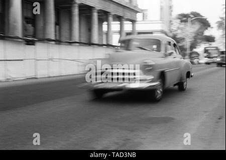 An American car speeds through the city of Havana Cuba Stock Photo