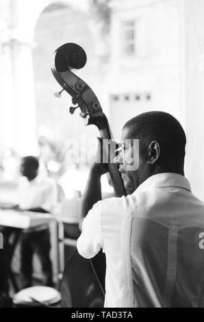 A bass player entertains the crowd in Havana Cuba Stock Photo