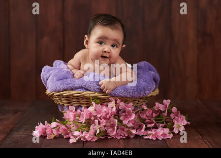 Smiling cute baby girl portrait on dark studio background Stock Photo