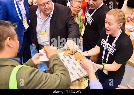 Samples of meatless Impossible Burger shared at Impossible Foods exhibit booth. Vegetarian plant based burger. National Restaurant Show, Chicago, USA Stock Photo