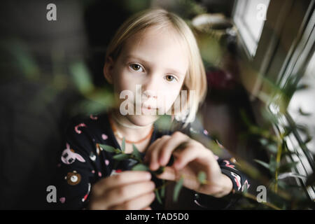 Portrait of blond little girl at home Stock Photo