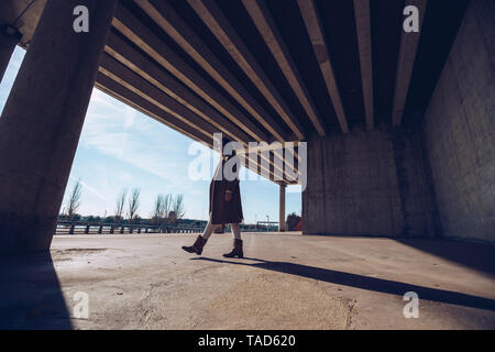Young woman walking at an underpass Stock Photo