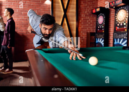 Man playing billiards Stock Photo