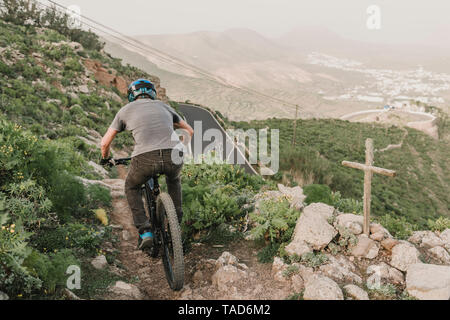Spain, Lanzarote, mountainbiker on a trail in the mountains Stock Photo