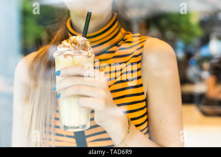 Close-up of teenage girl drinking a milk shake Stock Photo