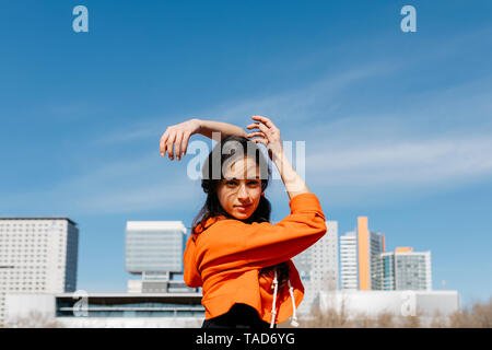 Young contemporary dancer wearing red hoodie shirt, practicing Stock Photo