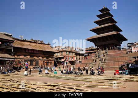 Bamboo scaffolding is piled in Taumadhi Tol, flanked by Newari buildings and the five-tiered Nyatapola pagoda temple, Bhaktapur, Kathmandu Valley, Nep Stock Photo