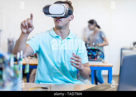 Technician using a VR headset in workshop Stock Photo