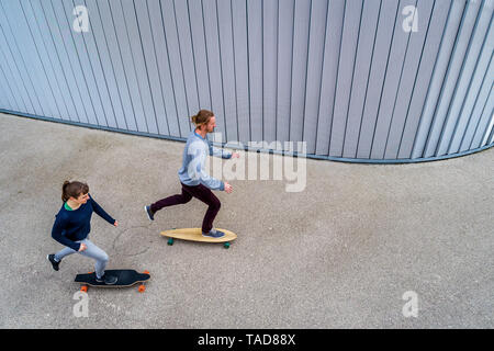 Young couple longboarding, seen from above Stock Photo