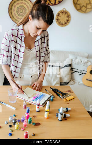 Woman painting at home Stock Photo