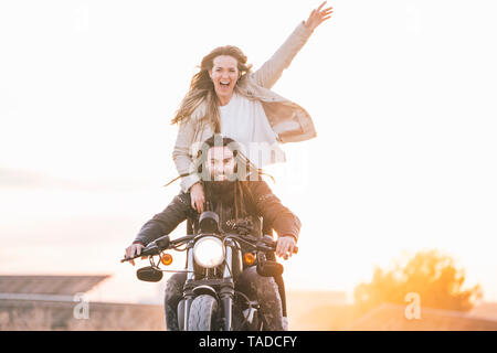Portrait of happy couple on motorbike Stock Photo