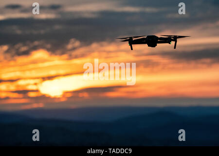 A drone flying above the Welsh countryside at sunset. Stock Photo