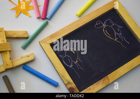 chalkboard with colorful chalk isolated on white background Stock Photo