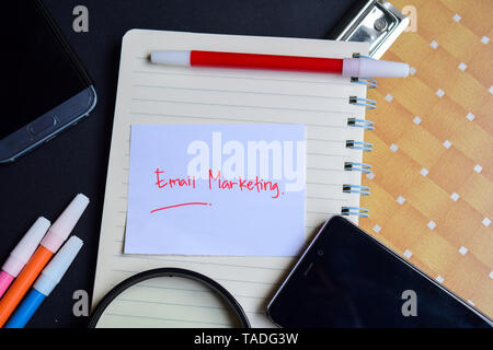 email marketing written on paper isolated on black table Stock Photo