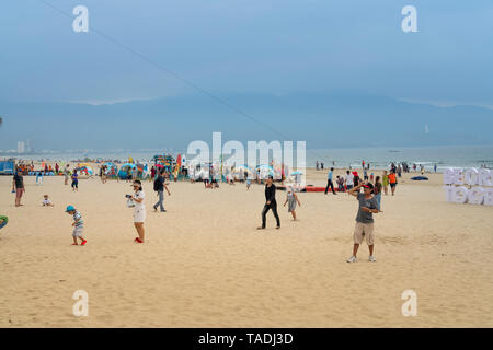 My Khe beach, Da Nang city, Vietnam - April 28, 2019: Parasailing at My Khe beach in Da Nang city. Popular entertainment for holiday travelers Stock Photo