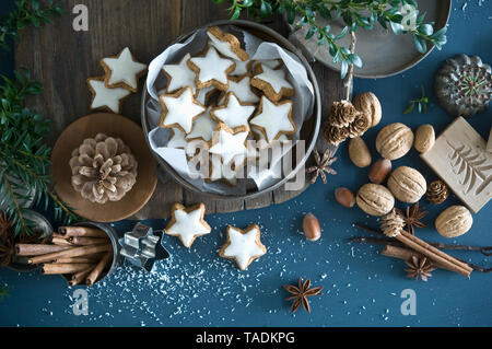 Cinnamon stars in tin can, star anise, cinnamon sticks, nutcracker and pine cones Stock Photo