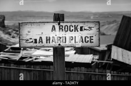 Between A Rock and A Hard Place desert direction sign Stock Photo