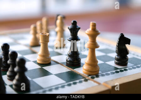 Wooden chess pieces on chessboard Stock Photo