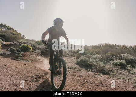 Spain, Lanzarote, mountainbiker on a trip in desertic landscape Stock Photo