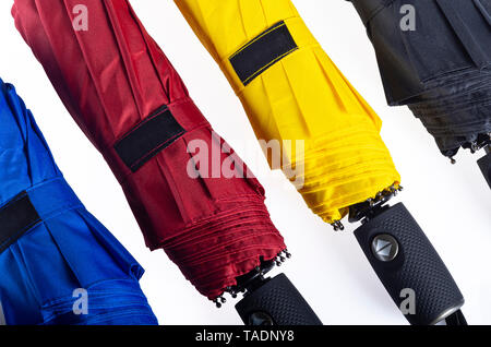 Multicolored folded umbrellas isolated on white Stock Photo