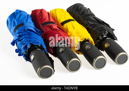 Multicolored folded umbrellas isolated on white Stock Photo
