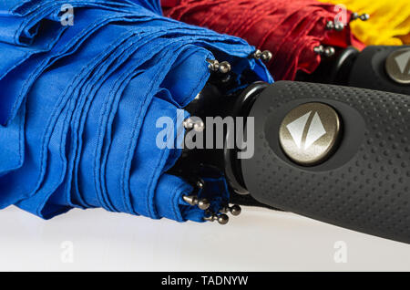 Multicolored folded umbrellas isolated on white Stock Photo